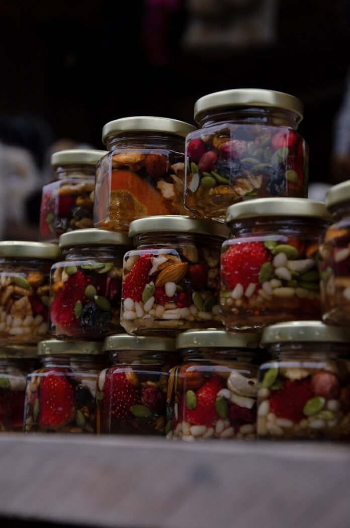 Photo by Vasha Nekrasova a bunch of jars filled with different types of food