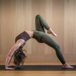 필라테스, 일상 속 건강한 습관으로 자리잡다 a woman is doing a yoga pose on a mat