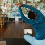 집콕 시간 늘어나는 요즘, ‘홈트’로 건강 챙기는 똑똑한 방법 a man doing yoga in a living room