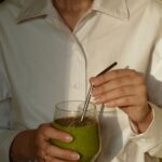 일상 속 웰니스 문화, 작은 변화가 만드는 건강한 습관 person in white button up shirt holding clear drinking glass with green liquid