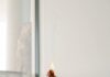 ‘나를 위한 작은 변화’…일상 속으로 들어온 웰니스 문화 person holding orange flower in front of white wall